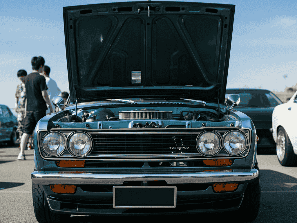 “Classic 1970s Datsun 510 with hood open showcasing L-series engine”