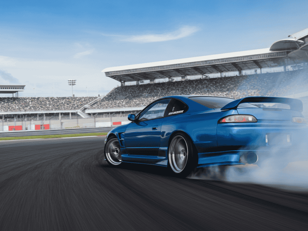 A Japanese motorsport car with JDM wheels in action on a race track
